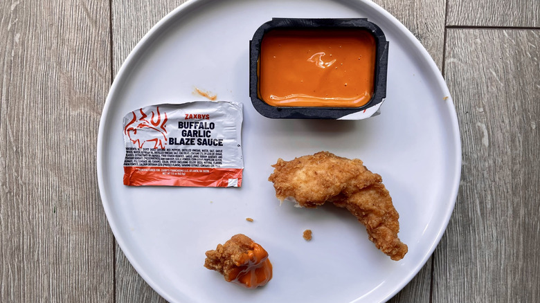 Chicken pieces with Buffalo Garlic Blaze Sauce on a plate