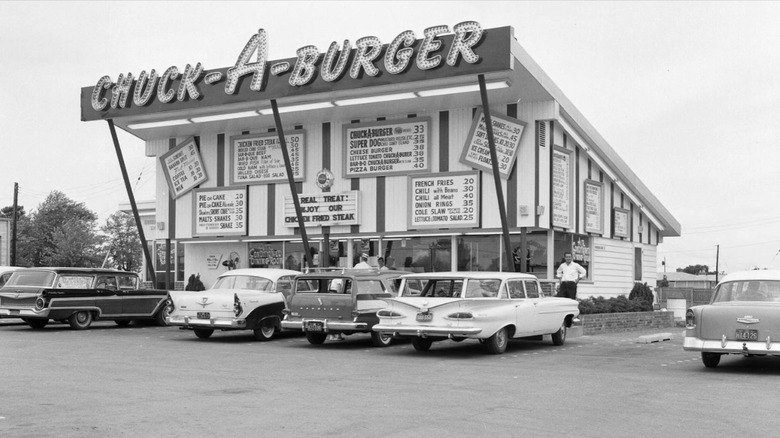 Black and white photo of exterior of Chuck-A-Burger in St. Louis with vintage cars