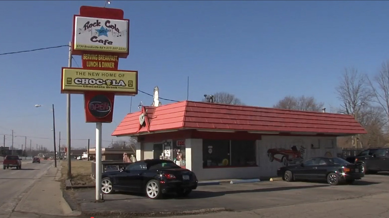 Exterior of Rock-Cola 50s Cafe with a sign and red roof