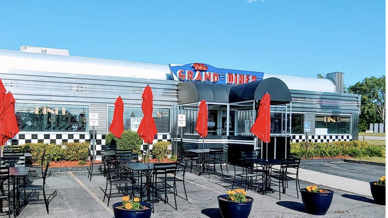 Exterior of the Grand Diner in Novi, MI, with red umbrellas