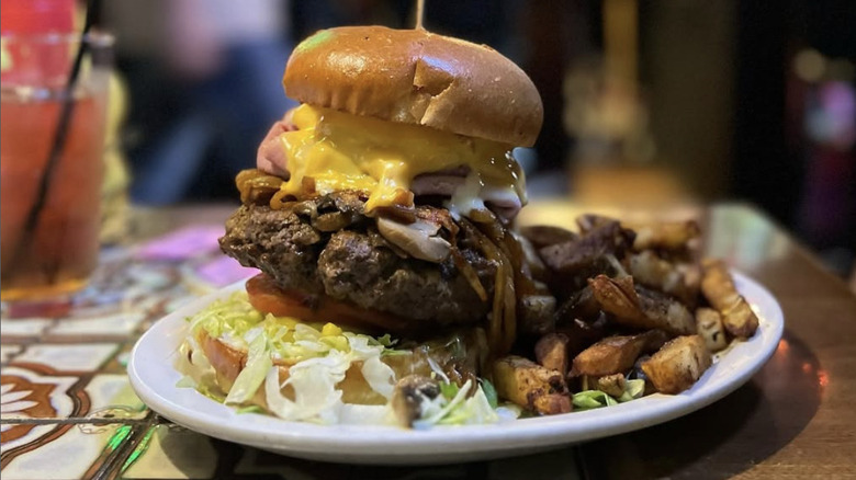 The Thurmanator burger at the Thurman Cafe on a white plate with fries