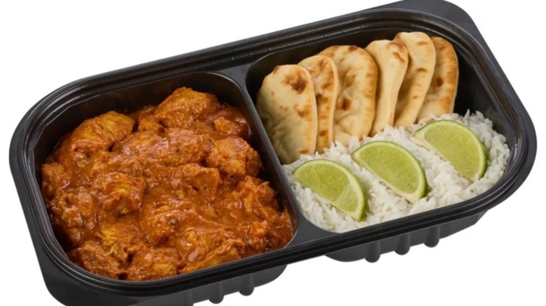 Sam's Club Member's Mark chicken tikka masala in a divided plastic deli tray with fresh limes, rice, and naan.