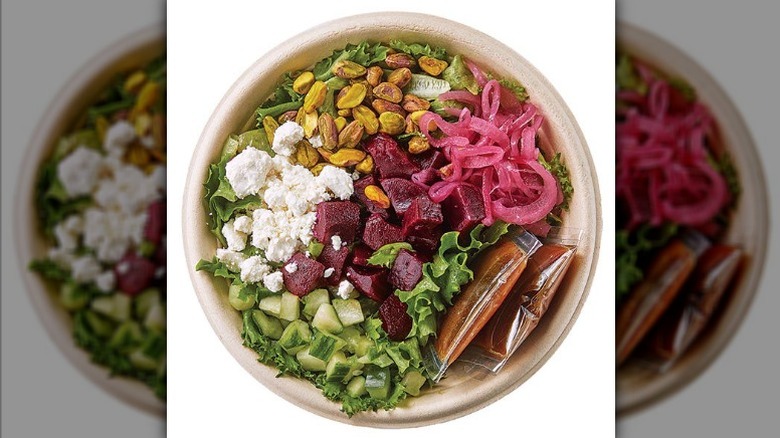 Wegmans roasted beet and goat cheese salad with greenhouse-grown lettuce, goat cheese crumbles, diced cucumbers, pickled red onions, pistachios, cooked beets, and a balsamic vinaigrette.