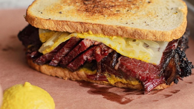 Reuben with smoked pastrami and cheese on tray