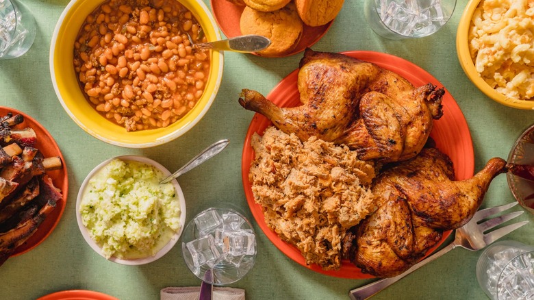 Assorted BBQ dishes from above including chicken, pork, baked beans, and cornbread