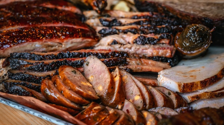 Plate of assorted BBQ meats including turkey, sausage, and ribs