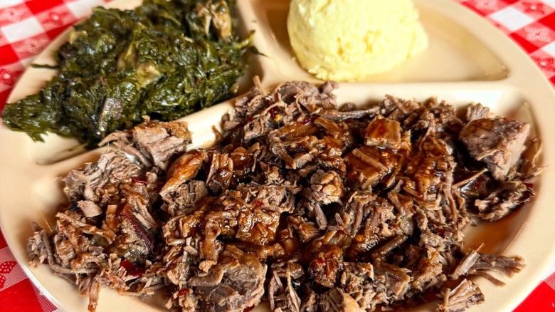 Tray with pulled pork, collard greens, and mashed potatoes