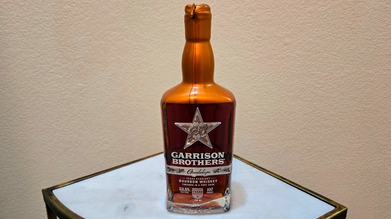 A bottle of Garrison Brothers Guadalupe Texas straight bourbon on a table