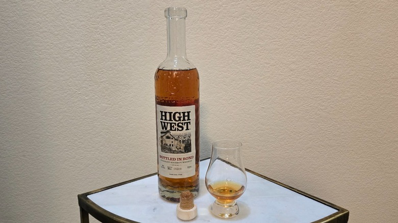 A bottle of opened High West Bottled In Bond bourbon with a glass