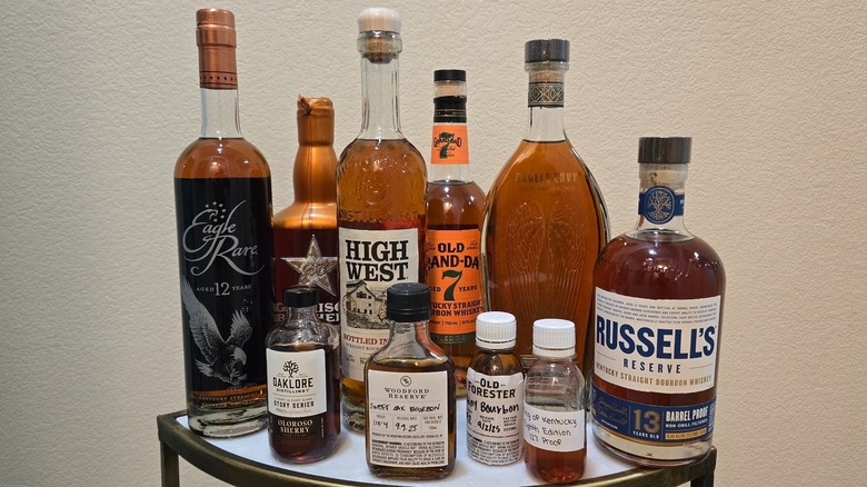 Bottles of bourbon released in 2025 with whiskey dram against a white background