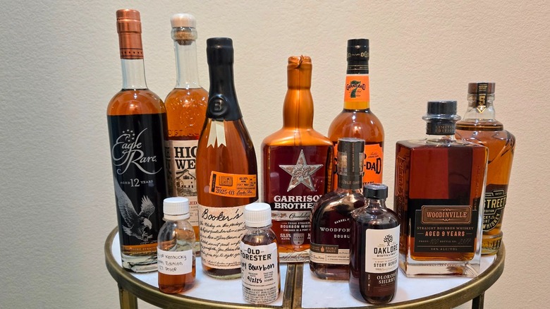 Bottles of bourbon released in 2025 assembled on table against a white background
