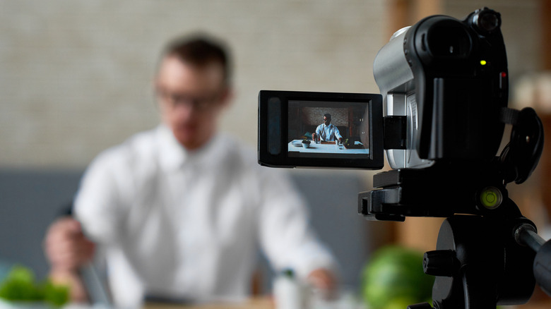 Camera shooting a man cooking