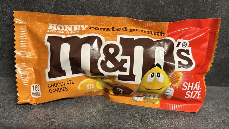 An orange-red package of roasted peanut M&M's