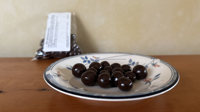Chocolate cordials on plate in front of bag