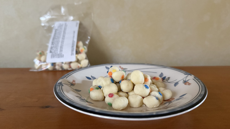 Birthday cake cookie dough bites on plate in front of bag