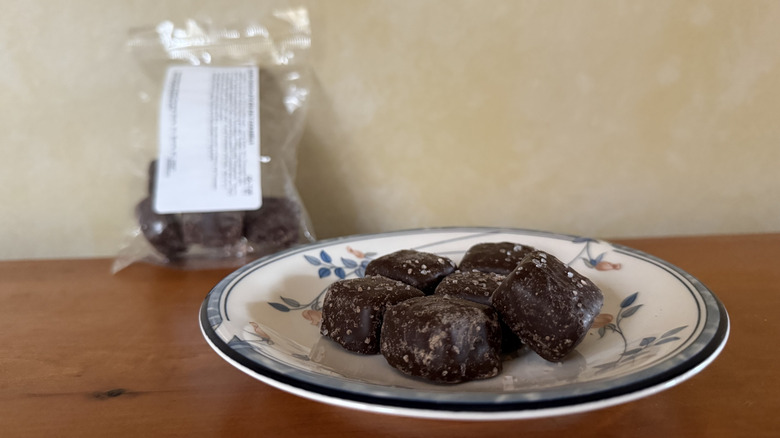 Dark chocolate sea salt caramels on plate in front of bag