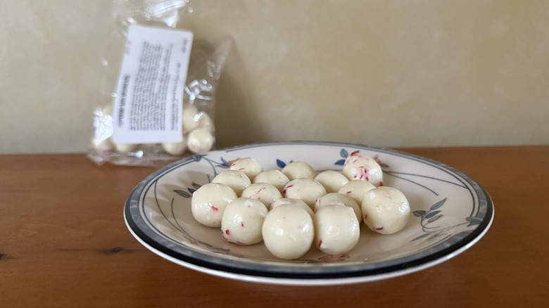 Peppermint brownie bites on plate in front of bag
