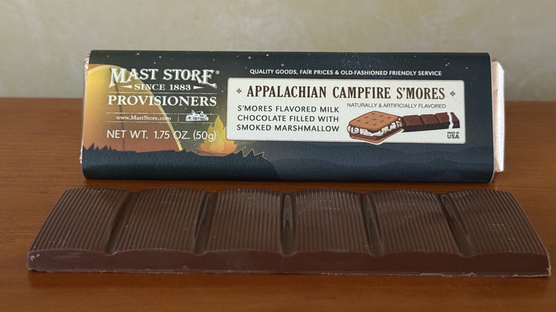 Appalachian campfire s'mores chocolate bar in front of wrapper on wooden table