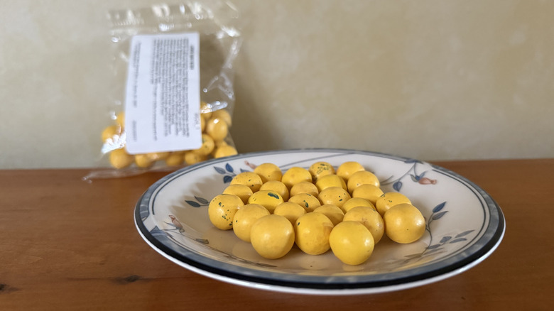 Lemon twist bites on plate in front of bag