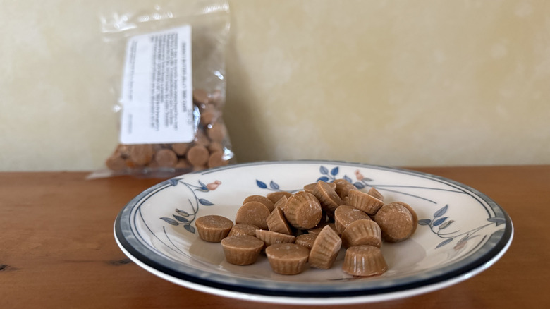 Small peanut butter jelly time cups on plate in front of bag
