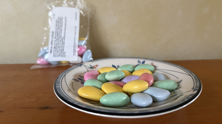 Premium Jordan almonds on plate in front of bag