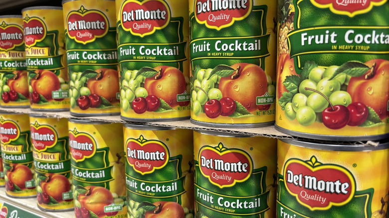 Rows of Del Monte fruit cocktail cans on display