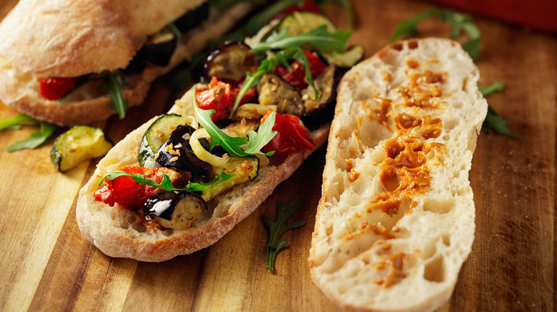 Roasted vegetable submarine on a wooden cutting board