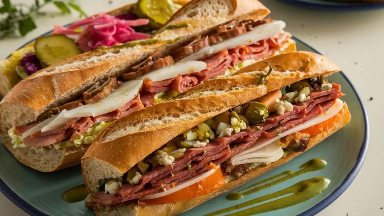 Muffuletta submarine sandwiches on a green plate
