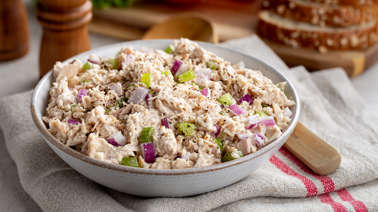 Tuna salad with celery and red onions in a white bowl