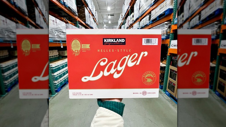 Hand holding box of Kirkland Signature Helles-Style Lager