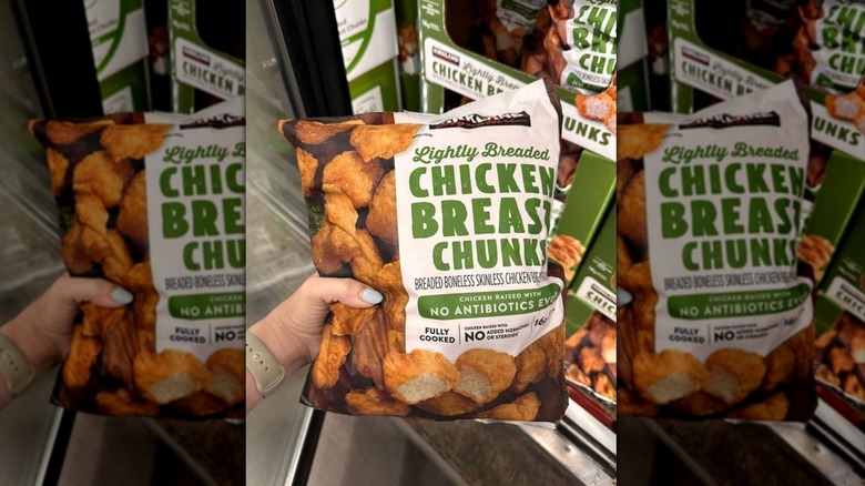 Hand holding bag of Kirkland Signature Lightly Breaded Chicken Chunks