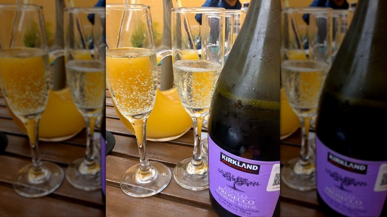 Bottle of Kirkland Signature Asolo Prosecco Superiore DOCG with two wine flutes
