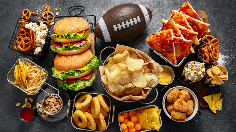 Variety of foods and football on grey surface