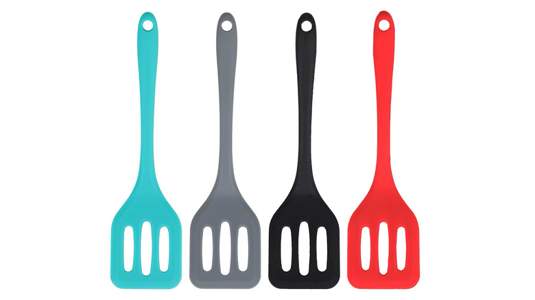 Four silicone spatulas in teal, grey, black, and red colors