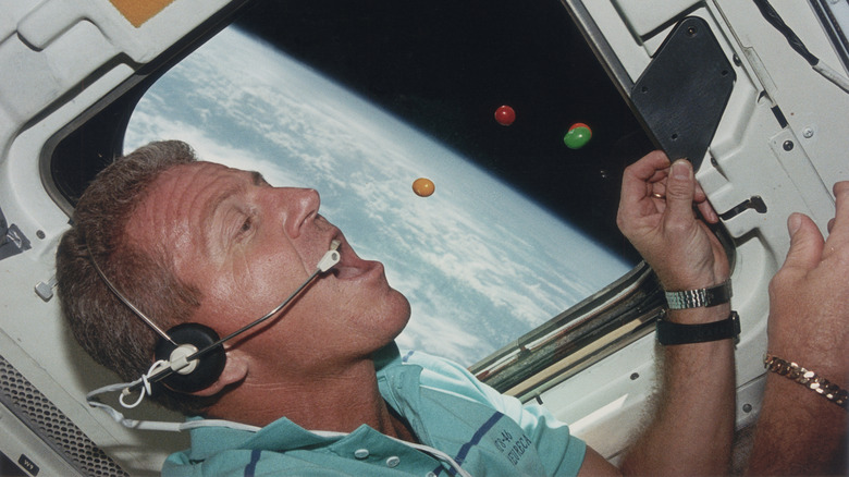 An astronaut eating candy in outer space