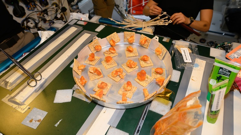 The ISS crew eating rehydrated shrimp cocktails and crackers