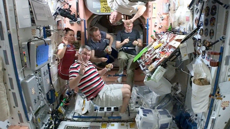 International Space Station crew members eating Thanksgiving dinner