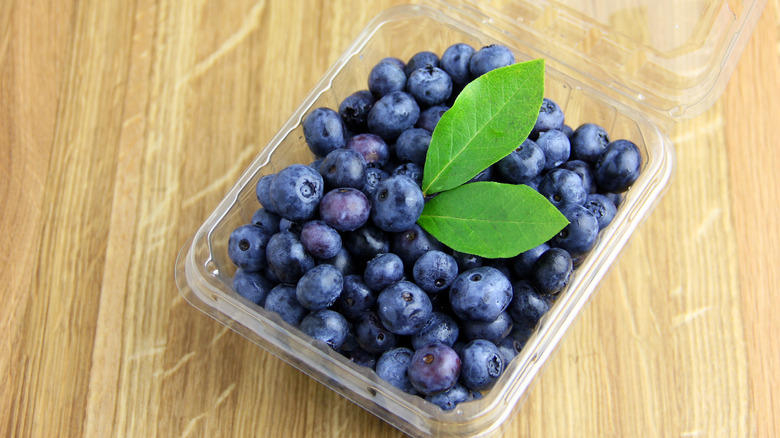 A pack of wild Maine blueberries on a wooden surface