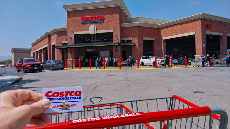 Person holding a Costco card outside Costco