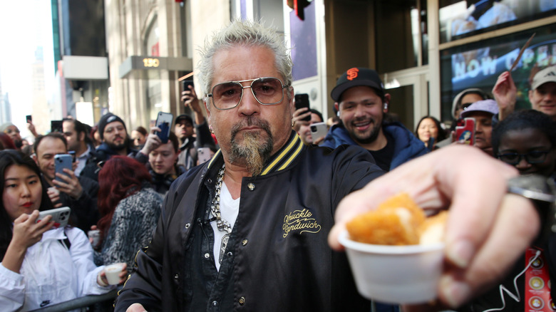 Guy Fieri holding out samples