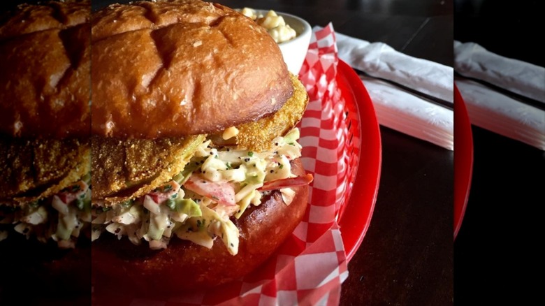 Fried green tomato sandwich on red tray