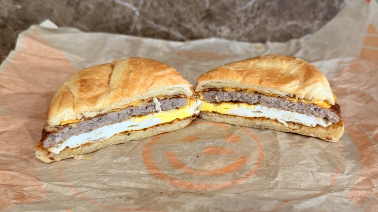 Jack in the Box Sausage Croissant sandwich cut in half