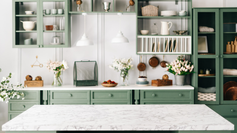 Green and white kitchen with mementos