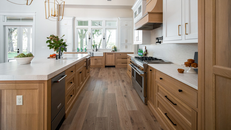Kitchen filled with custom, uniform wooden cabinetry with white details