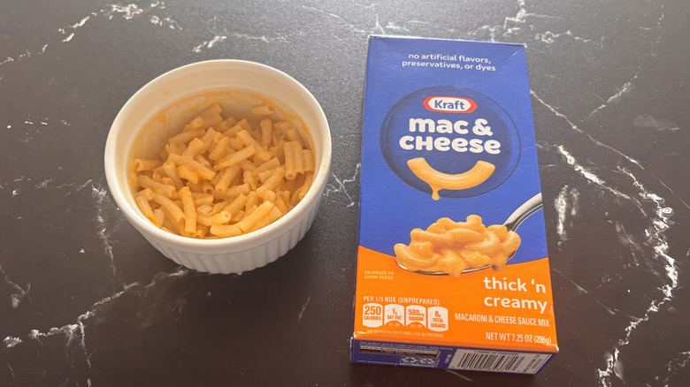 Kraft thick 'n creamy mac and cheese box next to bowl of mac and cheese