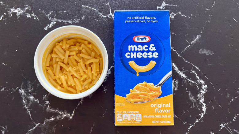 Kraft original mac and cheese box next to bowl of mac and cheese