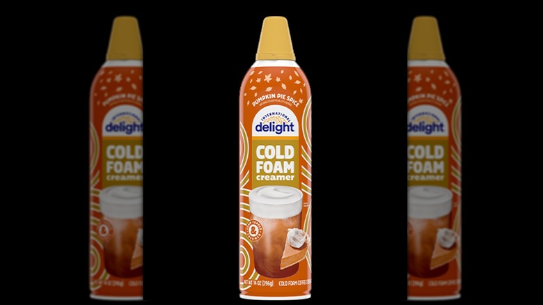 a bottle of International Delight Pumpkin Pie Spice Cold Foam Coffee Creamer against a black backdrop