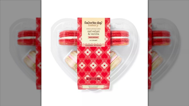 Red and white macarons in plastic box