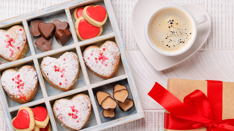 box of Valentine's Day candies and cookies with coffee and gift box