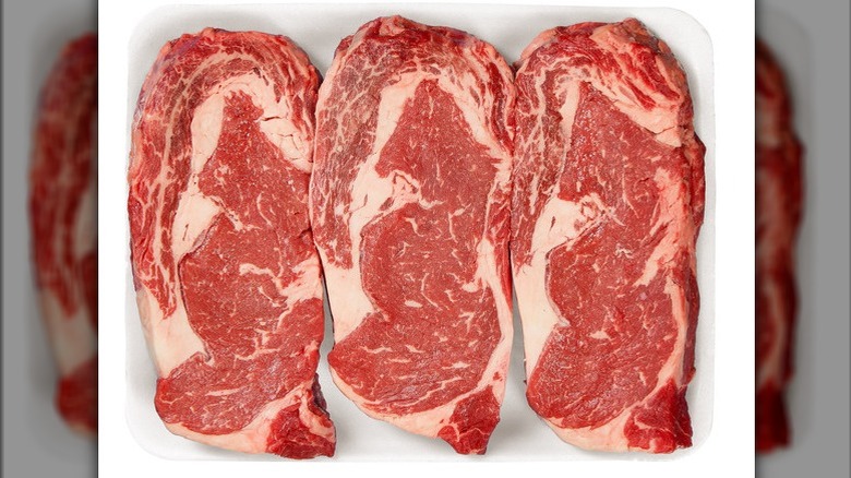 Ribeye steaks on white background